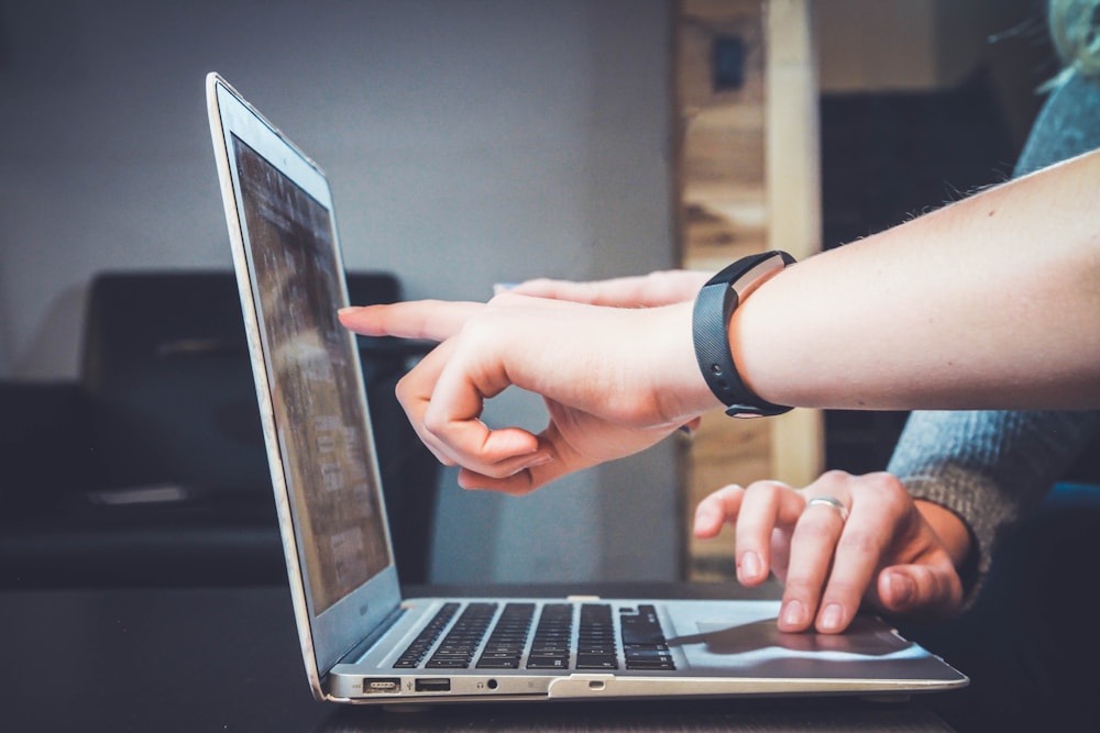 Reviewing supplier details and sourcing messages on a laptop